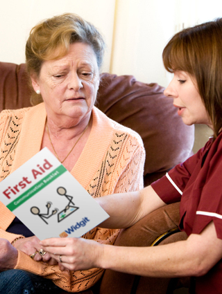 Nurse ust=ing the first aid booklet